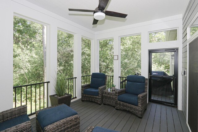 sunroom / solarium featuring ceiling fan