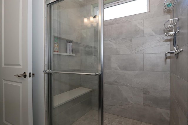 bathroom with a shower with shower door