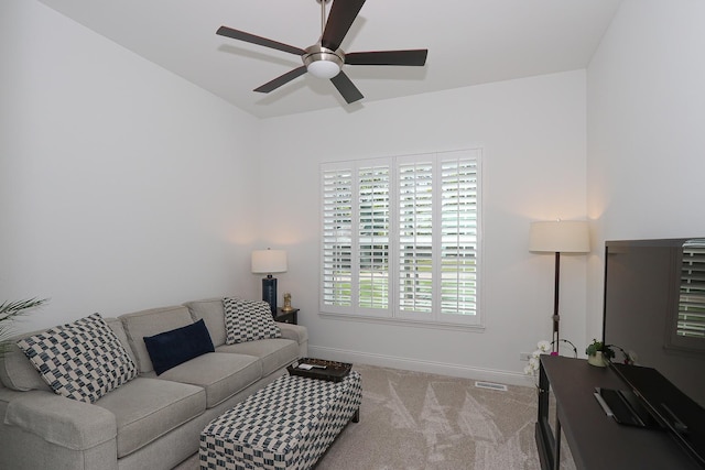 carpeted living room with ceiling fan