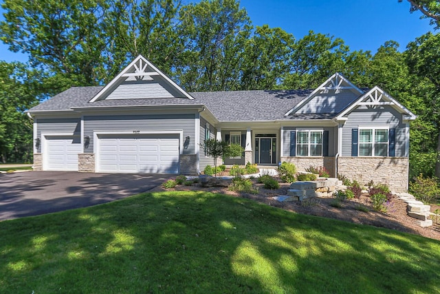 craftsman inspired home with a garage and a front yard