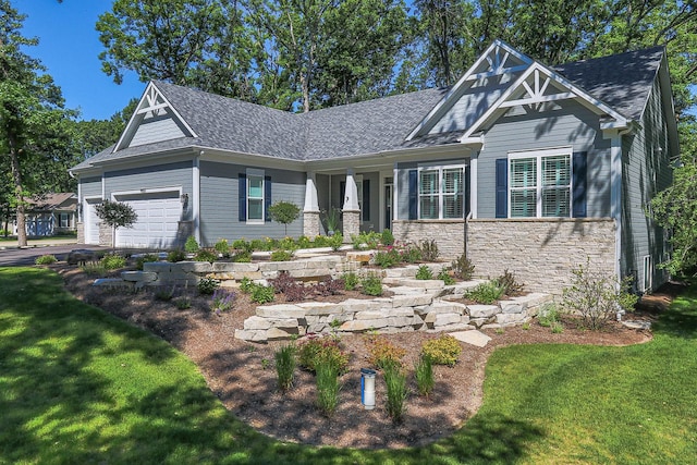 craftsman-style home with a front yard and a garage