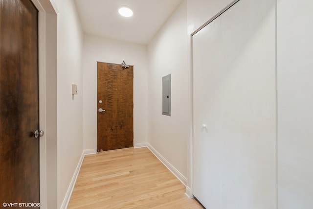 hallway featuring light hardwood / wood-style floors and electric panel