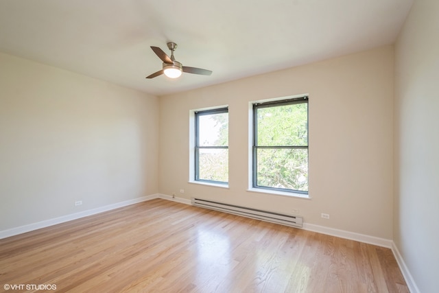 spare room with light wood-type flooring, ceiling fan, and baseboard heating