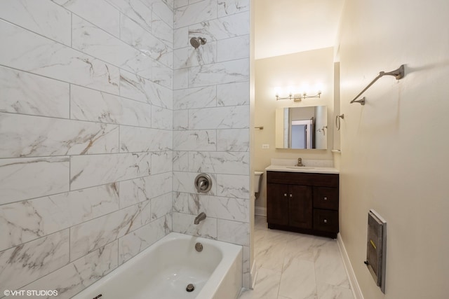 bathroom featuring vanity, heating unit, and tiled shower / bath