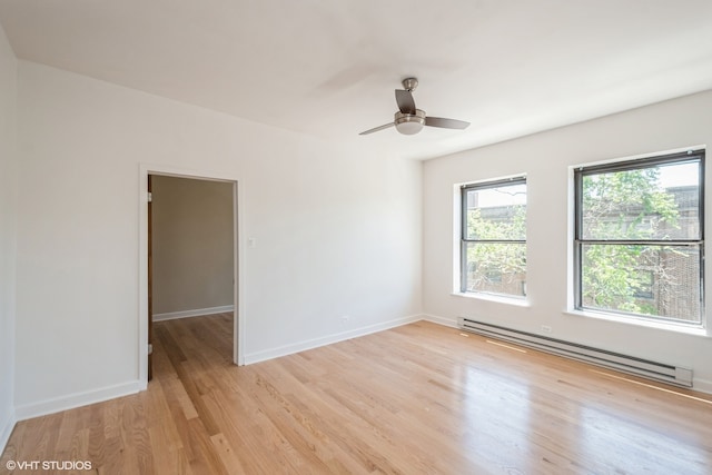 unfurnished room featuring light wood-type flooring, ceiling fan, and baseboard heating