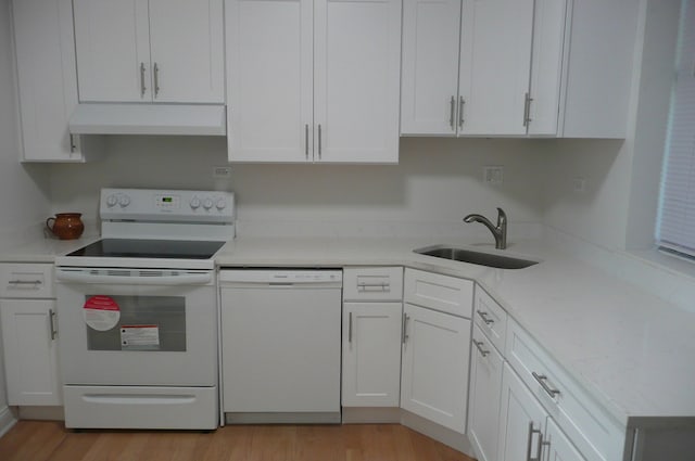 kitchen with white cabinets, light hardwood / wood-style flooring, sink, and white appliances