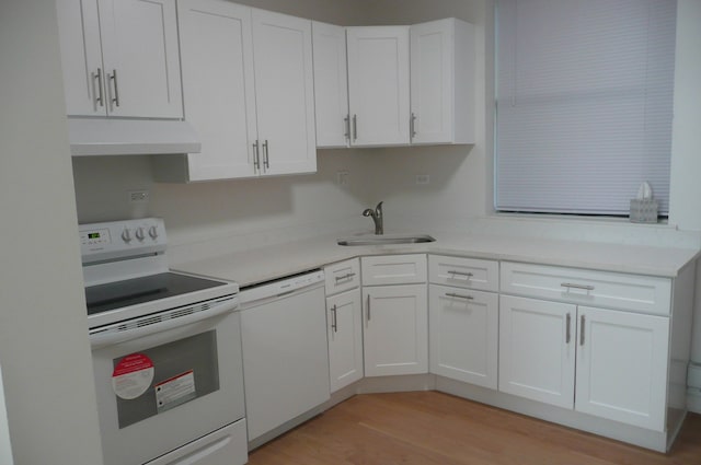 kitchen featuring white appliances, white cabinetry, sink, and light hardwood / wood-style flooring