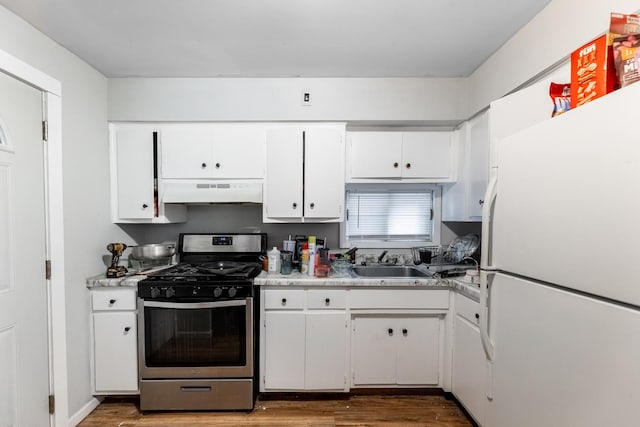 kitchen with white cabinetry, sink, stainless steel gas range, white fridge, and custom exhaust hood