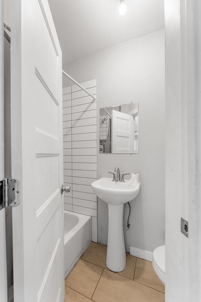 full bathroom with bathtub / shower combination, baseboards, toilet, and tile patterned floors