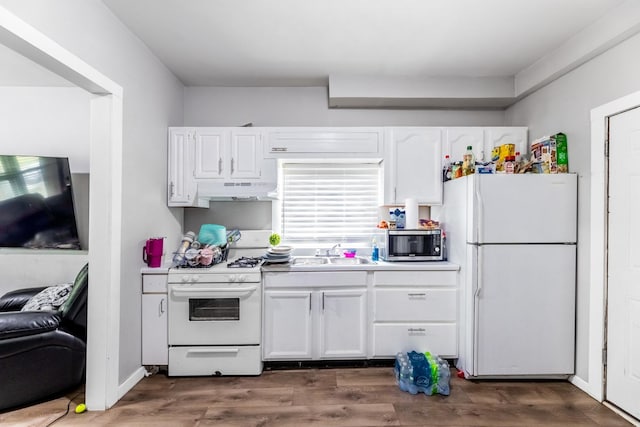 kitchen with dark wood-style floors, light countertops, white cabinetry, a sink, and white appliances