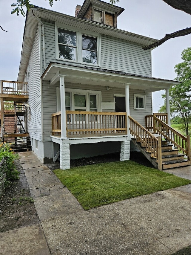 traditional style home featuring covered porch and stairs