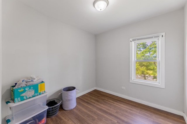 unfurnished room featuring baseboards and wood finished floors