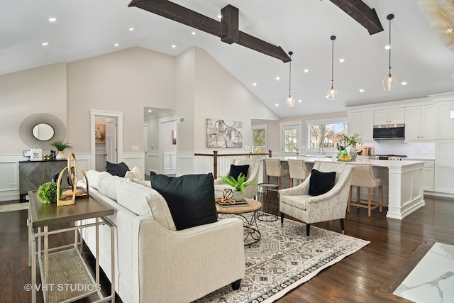 living room with beamed ceiling, dark hardwood / wood-style floors, and high vaulted ceiling