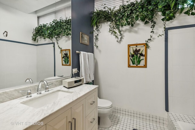 bathroom with vanity, toilet, and tile patterned flooring