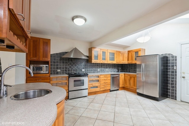 kitchen featuring backsplash, stainless steel appliances, sink, wall chimney range hood, and light tile patterned floors