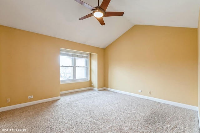 carpeted empty room featuring ceiling fan and lofted ceiling