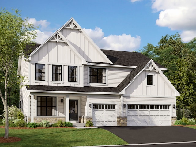 view of front of property featuring a front yard and a garage