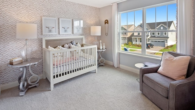 bedroom with carpet flooring and a nursery area