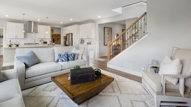 living room featuring sink and hardwood / wood-style floors