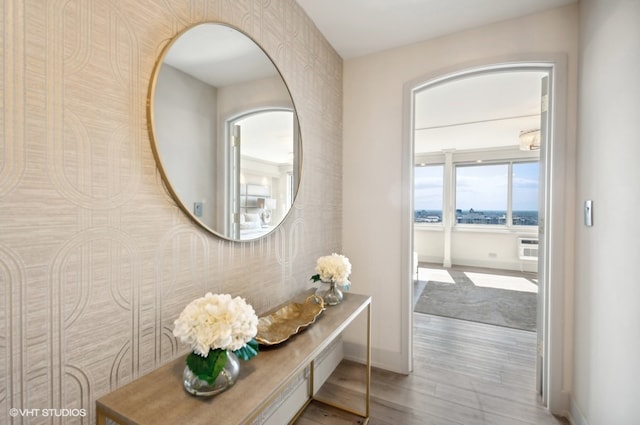 hallway with hardwood / wood-style flooring