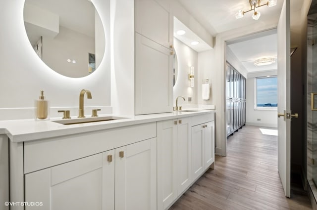 bathroom featuring double vanity and hardwood / wood-style floors