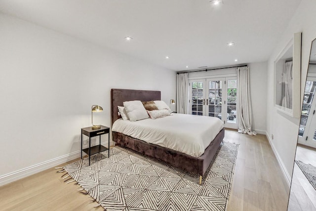 bedroom featuring access to outside, french doors, and light wood-type flooring