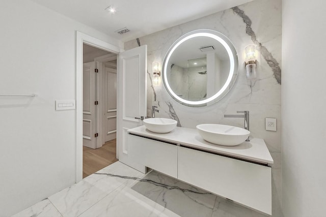 bathroom featuring tile walls, vanity, and a shower