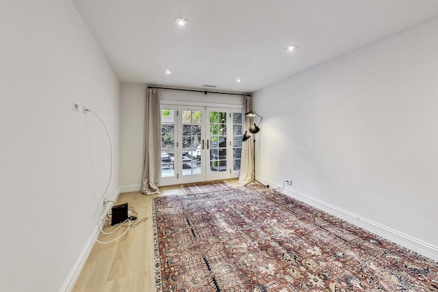 unfurnished room with french doors and wood-type flooring