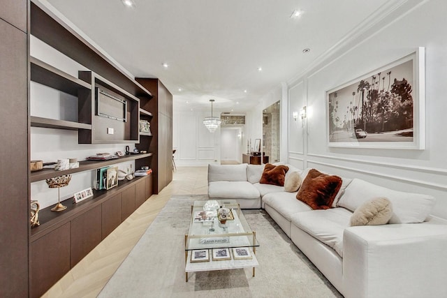 living room with crown molding and a notable chandelier