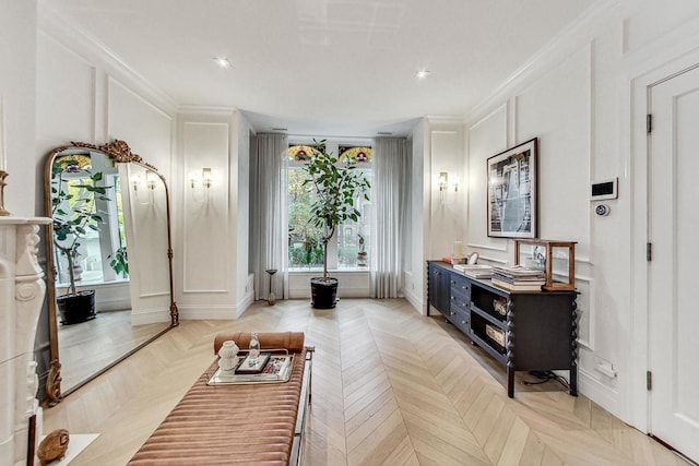 living room with ornamental molding and light parquet floors