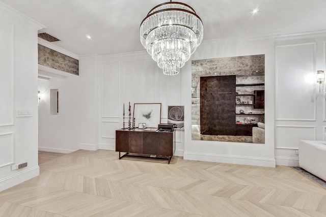 interior space featuring ornamental molding, a notable chandelier, and light parquet flooring