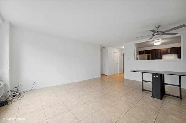 unfurnished room with ceiling fan and light tile patterned flooring