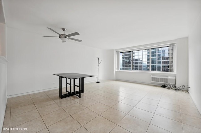 tiled empty room with a wall mounted AC and ceiling fan