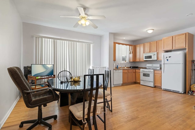 kitchen with light brown cabinets, ceiling fan, white appliances, and light hardwood / wood-style flooring