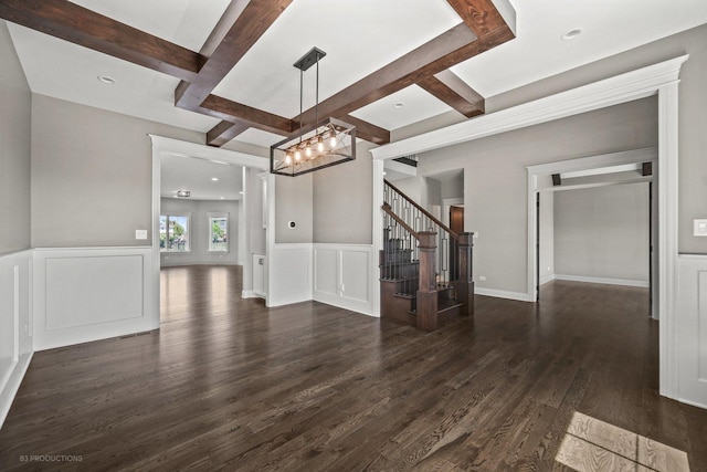 unfurnished living room with beamed ceiling, dark hardwood / wood-style flooring, a chandelier, and coffered ceiling