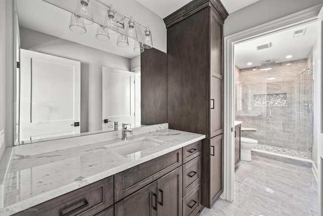 bathroom with vanity, toilet, and walk in shower