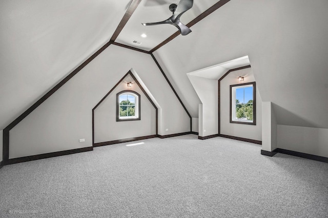 bonus room featuring light colored carpet, vaulted ceiling, and ceiling fan