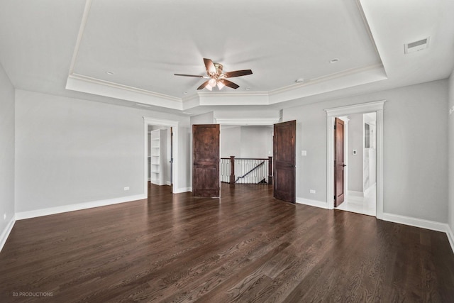 interior space featuring dark hardwood / wood-style floors, a raised ceiling, ceiling fan, and crown molding