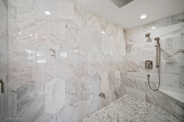 bathroom with a tile shower