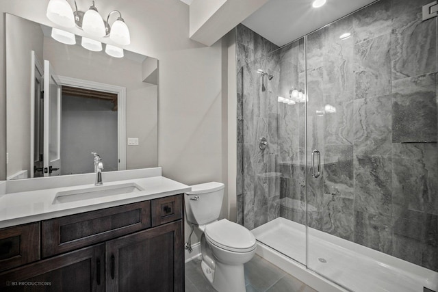 bathroom with vanity, a shower with shower door, and toilet