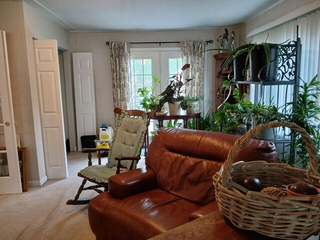 sitting room with light colored carpet and french doors