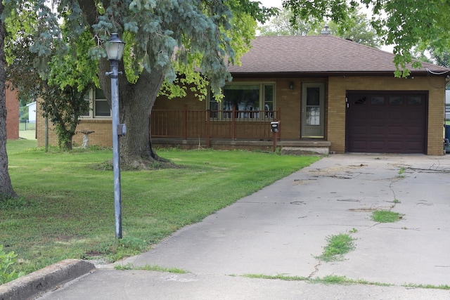 view of front of property with a front lawn, a porch, and a garage