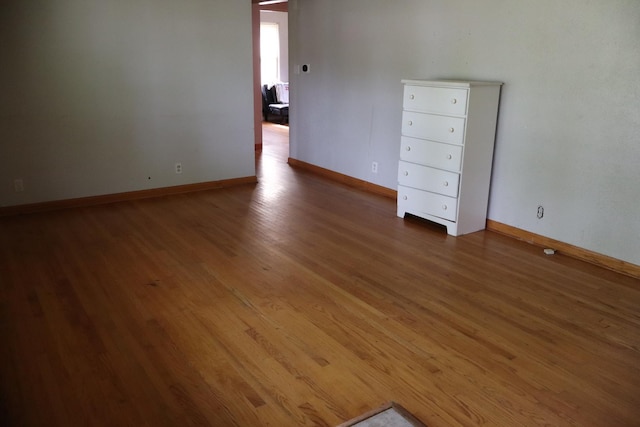 spare room featuring wood-type flooring