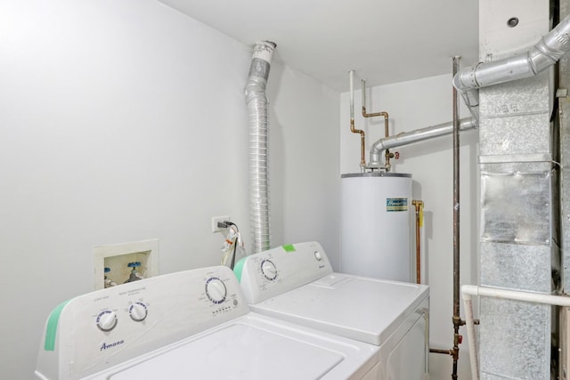 laundry area with gas water heater and washing machine and clothes dryer