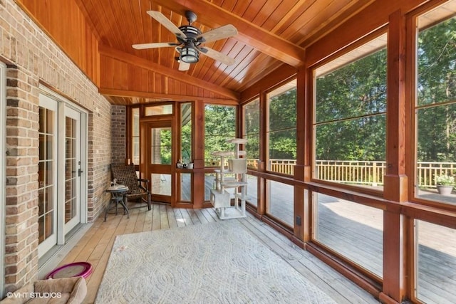 unfurnished sunroom featuring vaulted ceiling, wooden ceiling, french doors, and ceiling fan