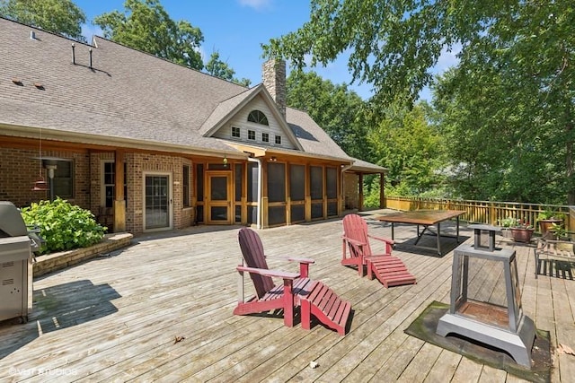 wooden terrace featuring a sunroom