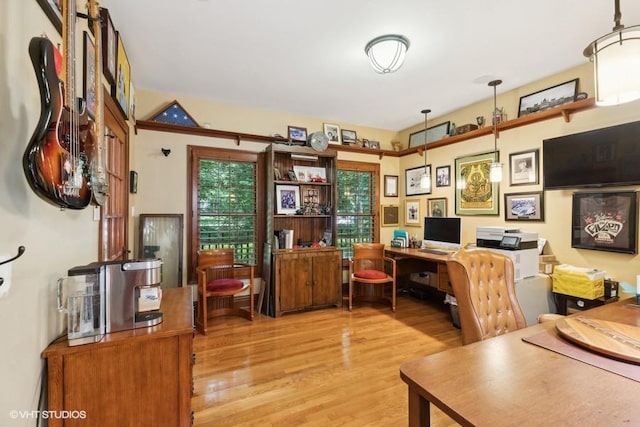 home office with light hardwood / wood-style flooring