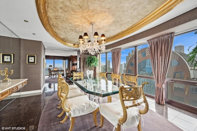 dining area with an inviting chandelier, a raised ceiling, and ornamental molding