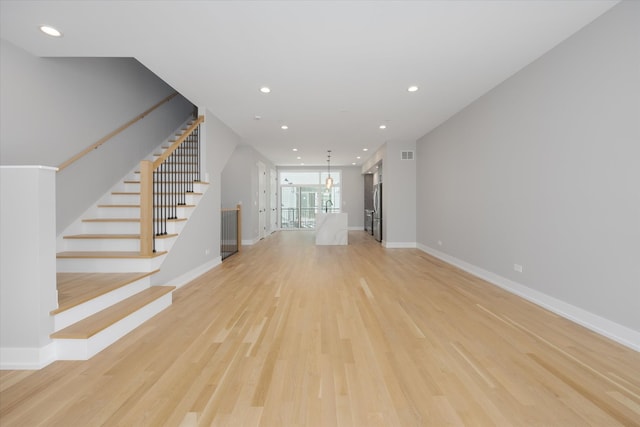 unfurnished living room with light wood-type flooring