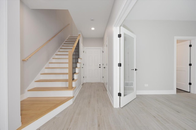 stairway featuring light hardwood / wood-style floors